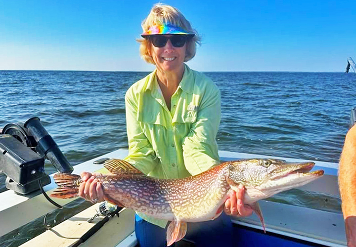 image of Sandy Hendrickson holding big northern pike from lake of the woods